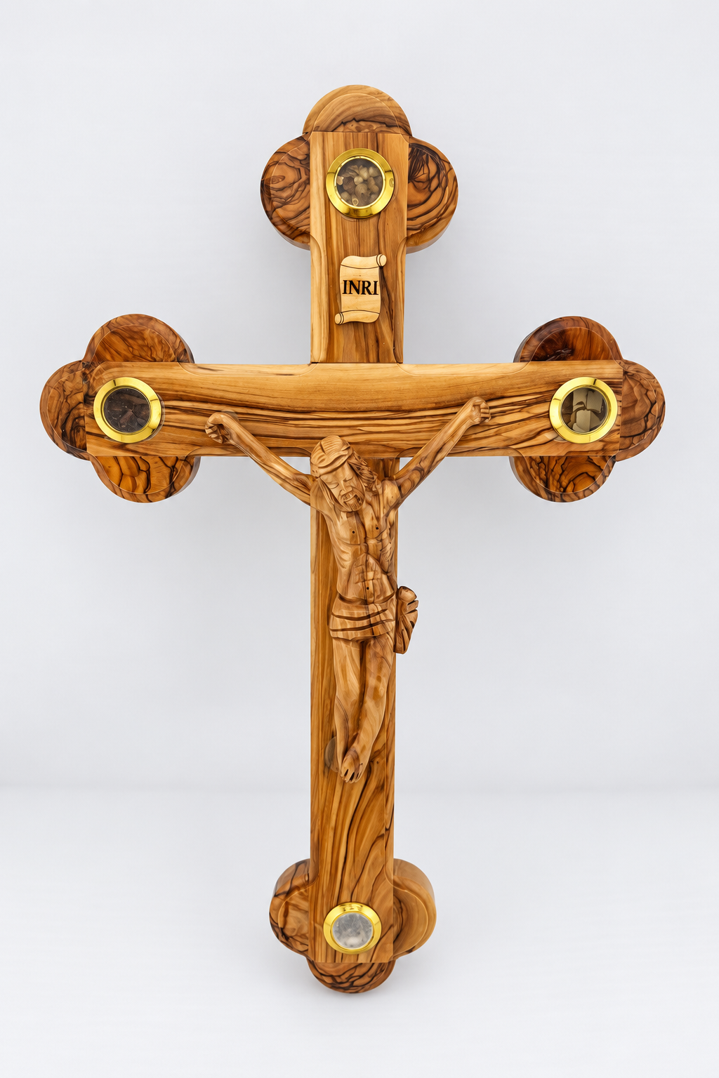 Budded olive wood crucifix with a figure of Christ, INRI plaque, and four circular gold-tone framed inlays.