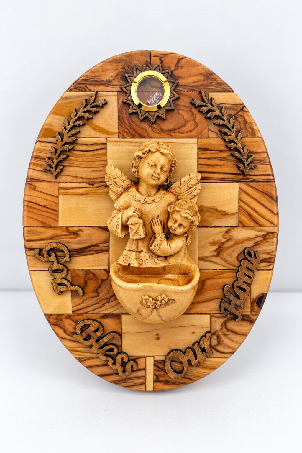 Oval olive wood wall plaque with an angel and child, decorative bowl, leaf accents, and God Bless Our Home lettering.