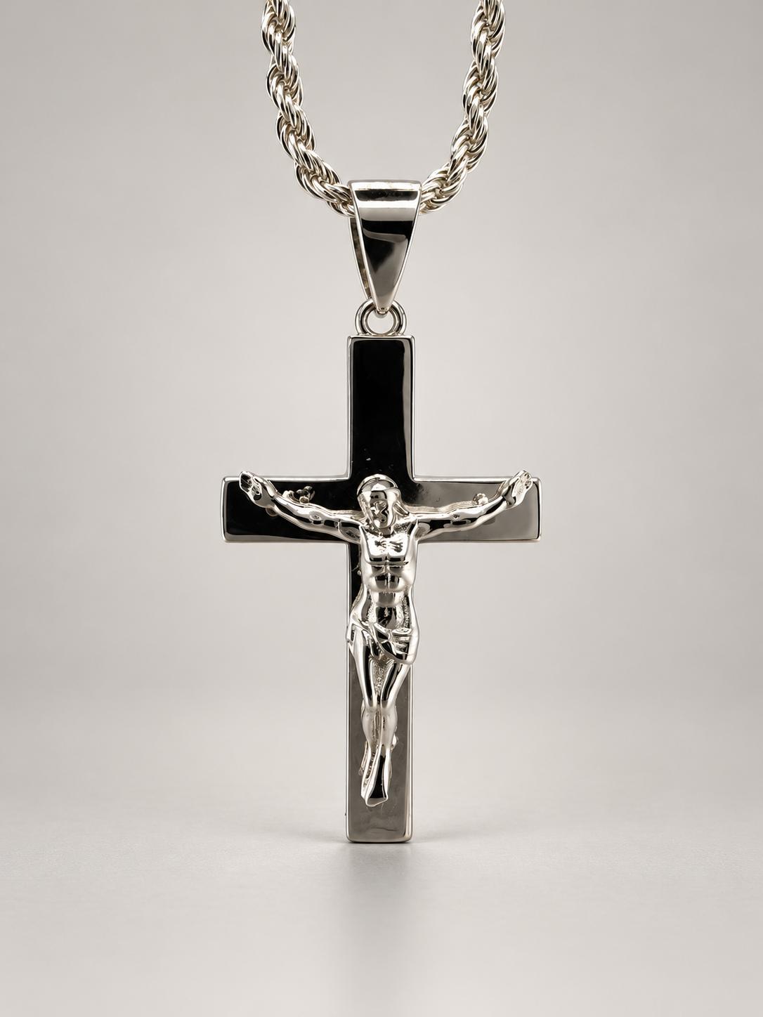 Silver-tone Jesus Christ crucifix pendant with a raised figure on a smooth reflective cross